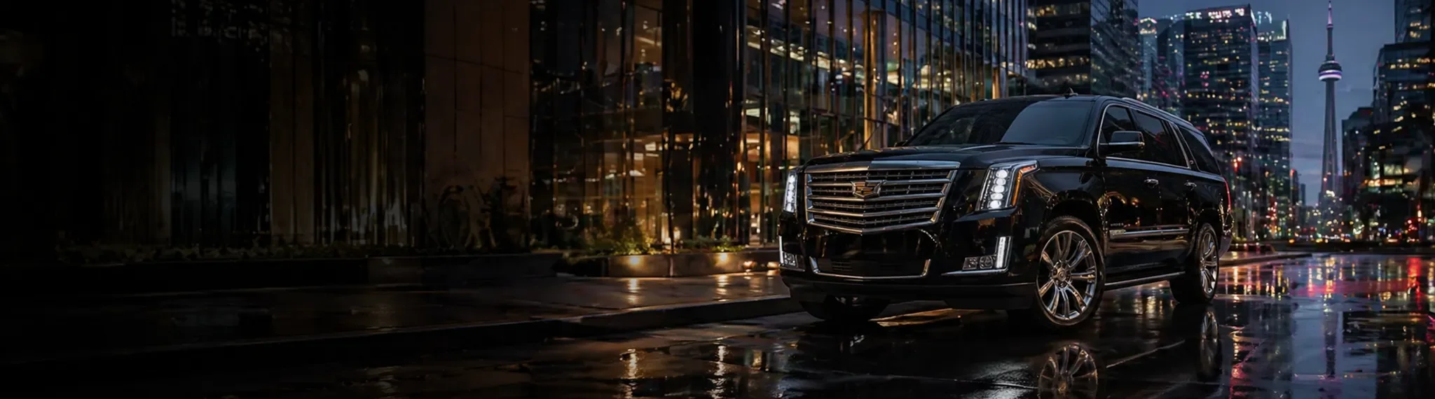 Black luxury SUV on a city street at night