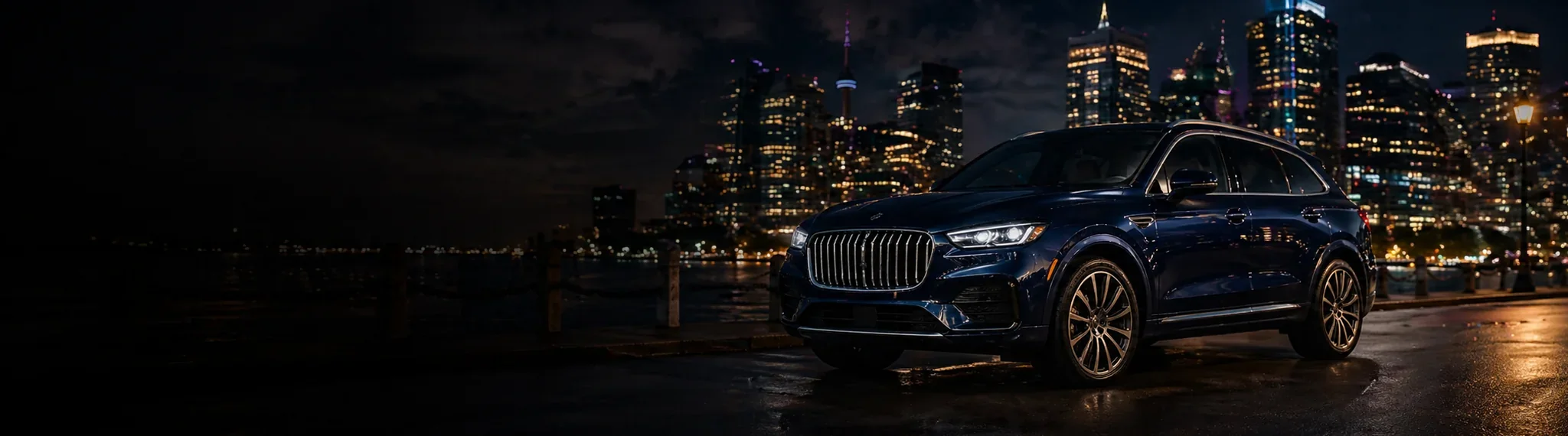 Black luxury SUV with the Toronto skyline at night